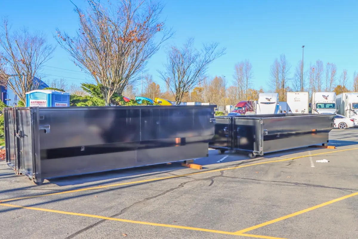 Professional dumpster rental service with roll-off container on residential driveway in Caln